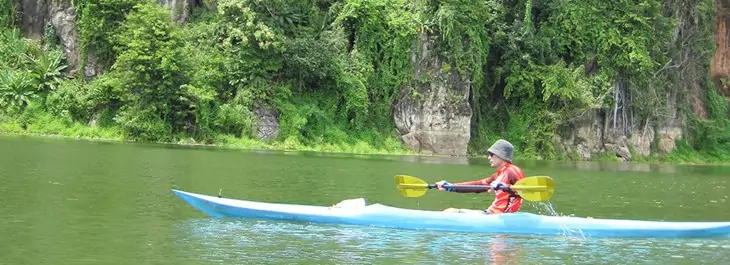 young man kayaking through a lake