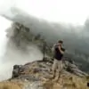 man taking photos on top of doi inthanon national park