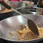 cooking pad thai in a wok