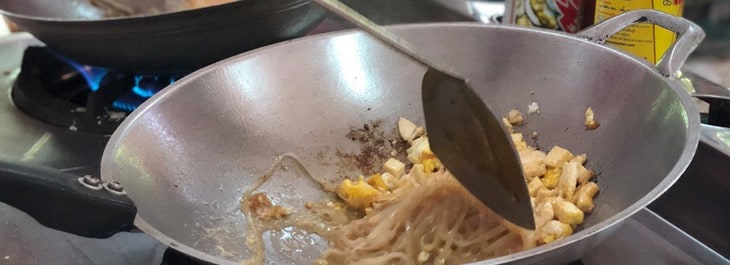 close up of pad thai cooking in wok