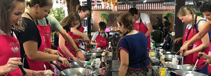 group of people learning Thai cooking
