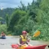 woman kayaking through chiang dao jungle river