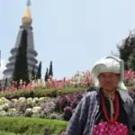 hill tribe lady in front of pagoda on doi inthanon