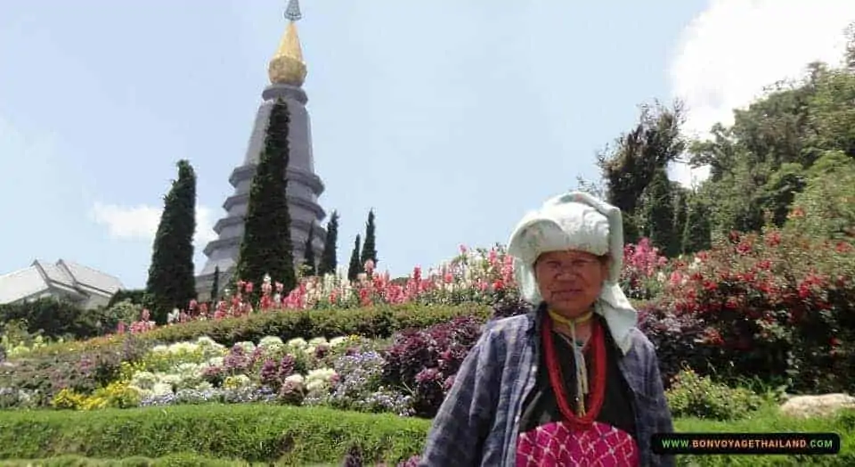 hill tribe lady in front of pagoda on doi inthanon