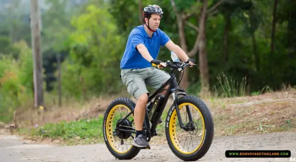 man riding on e-bike on hill