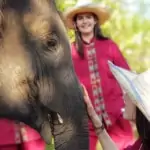 close up of woman bonding with elephant