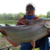 fisherman holding his catch - giant mekong catfish