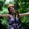 woman ziplining through jungle
