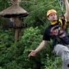 man ziplining through jungle