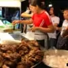 people buying food from local street food stall