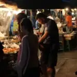 people buying food at local street food stall