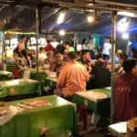 people eating at local street food market