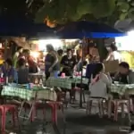 people eating at local street food market