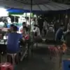 people eating at local street food market