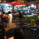 people eating at local street food market