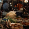 woman buying food from local street food stall