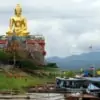 golden buddha statue and boats to laos