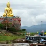 golden buddha statue and boats to laos