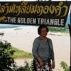 woman posing with the golden triangle sign
