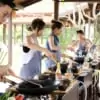 group of people cooking thai food at cooking station