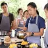 group of people learning to prepare mango and sticky rice