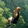 woman ziplining at jungle flight while giving a thumb-up
