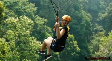 woman ziplining at jungle flight while giving a thumb-up