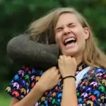 close up of young woman laughing and playing with elephant