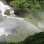 cascading waterfall with rainbow