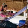 long neck karen woman in traditional costume weaving