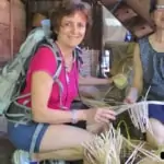 elder woman making basket from bamboo