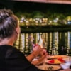 man and woman enjoying traditional thai dinner on ping river cruise