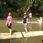 group of people bamboo rafting along mae wang river