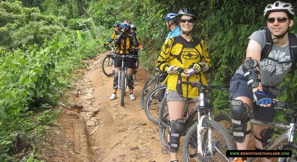 group of people biking through mountain