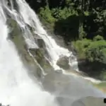 cascading waterfall with rainbow