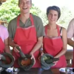 men and women making homemade curry paste