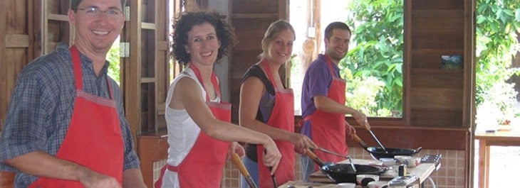 men and women cooking authentic thai food