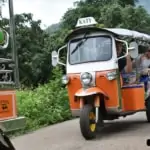 a convoy of tuk-tuks in Thai countryside