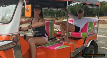 young women driving a tuk-tuk