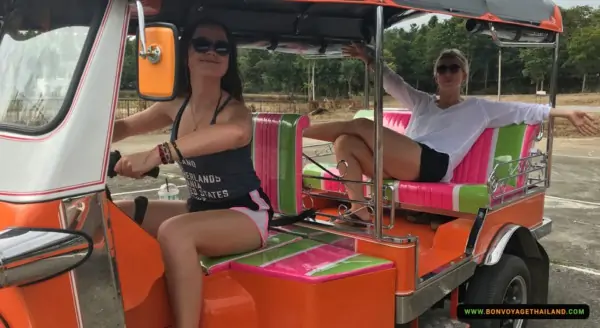 young women driving a tuk-tuk