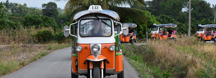 a convoy of tuk-tuks in Thai countryside