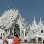 tourists taking photos of white temple or wat rong khun