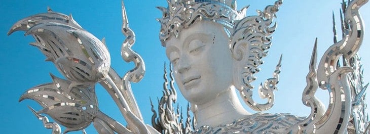 close up of buddha statue at white temple (wat rong khun) in chiang rai