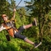 woman ziplining through jungle