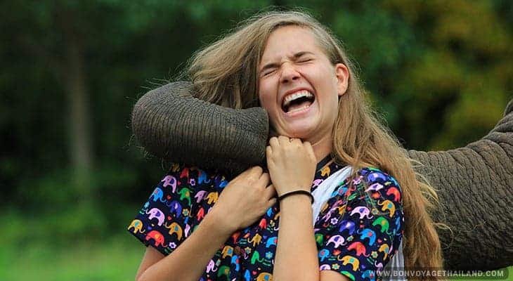 young woman bonding with elephant at knata elephant sanctuary