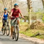 cycling along the road at lisu lodge