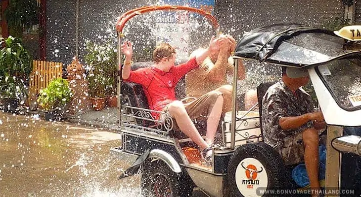 water splashing on people in tuk tuk during songkran festival in chiang mai