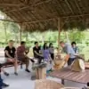 group of people learning about tea at araksa tea garden