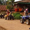 kids and adults enjoying riding atv through mountain village