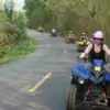 people enjoying riding atv through nature